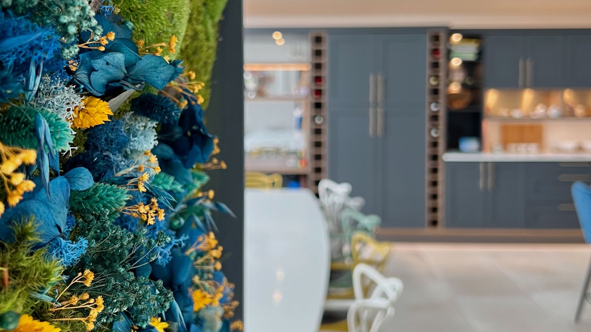 A stunning kitchen surrounded by colourful flowers.